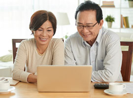 Older couple on laptop at home